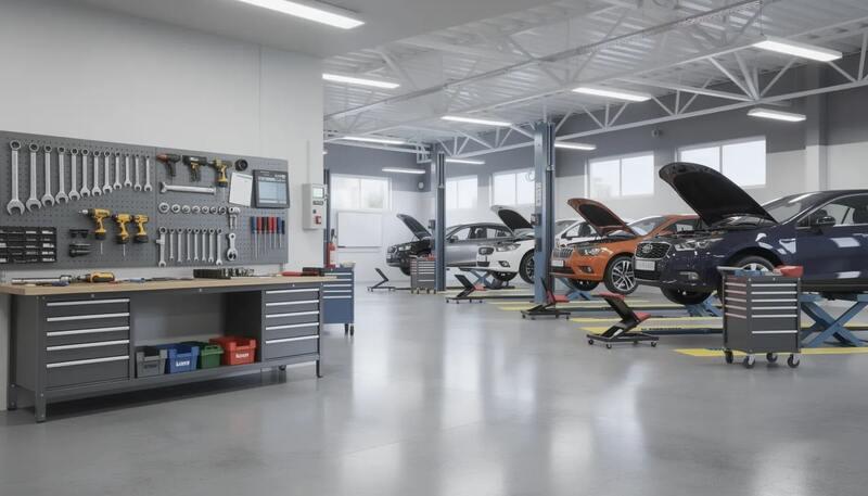 L'image montre un atelier automobile moderne où plusieurs voitures sont en cours de réparation, avec des outils soigneusement organisés sur un établi. Cet espace reflète le métier de mécanicien automobile, illustrant des compétences techniques nécessaires pour l'entretien et la maintenance des véhicules.